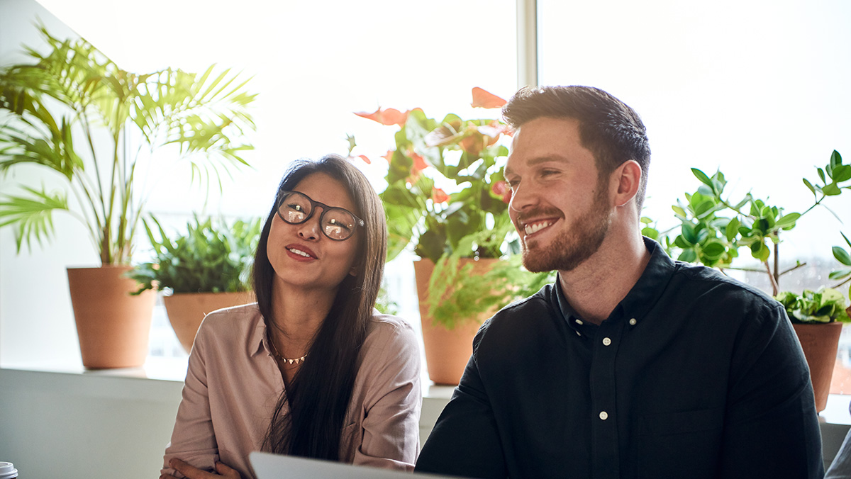 To personer taler og smiler